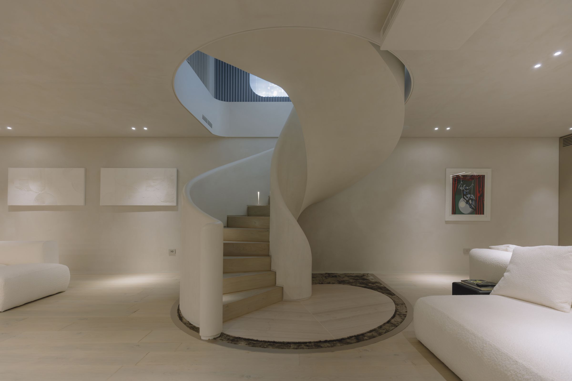 Helical staircase at the centre of the lower-floor lounge, Villa D.F.