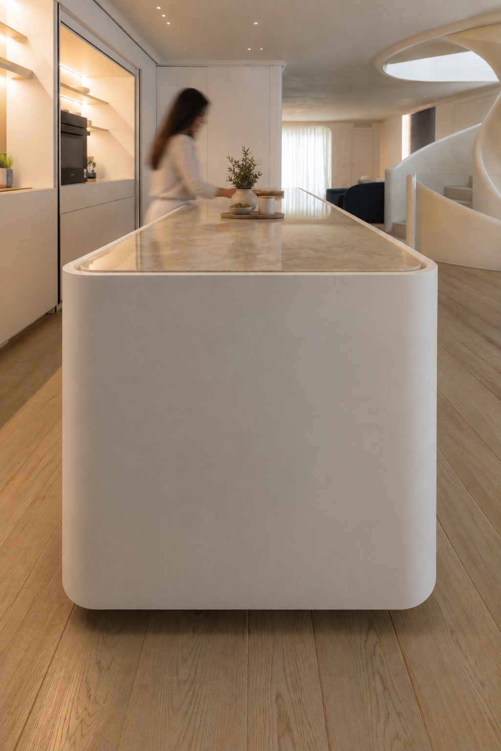 Stone and white lacquer island at Villa D.F., with a person passing in the background